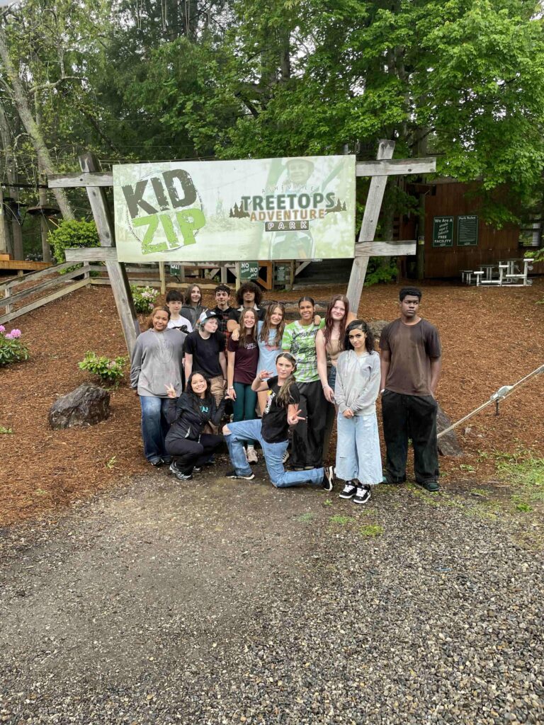 kids in front of Kid Zip sign outside